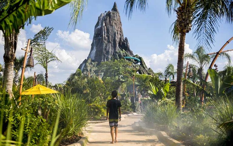 boy walking toward volcano slide tower at universal volcano bay orlando