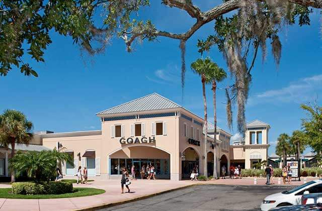 coach store with shopping near parking and trees at ellenton premium outlets florida