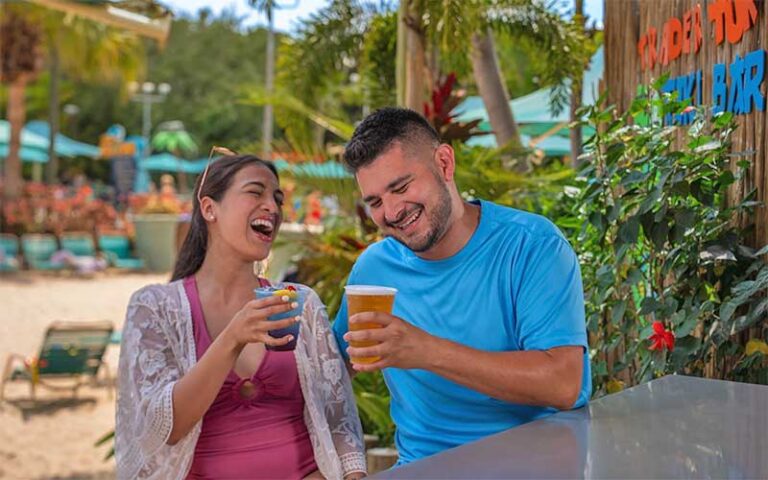 couple having drinks at tiki bar at aquatica orlando