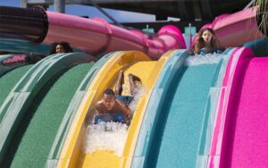 couple sliding down colorful water ride at aquatica orlando