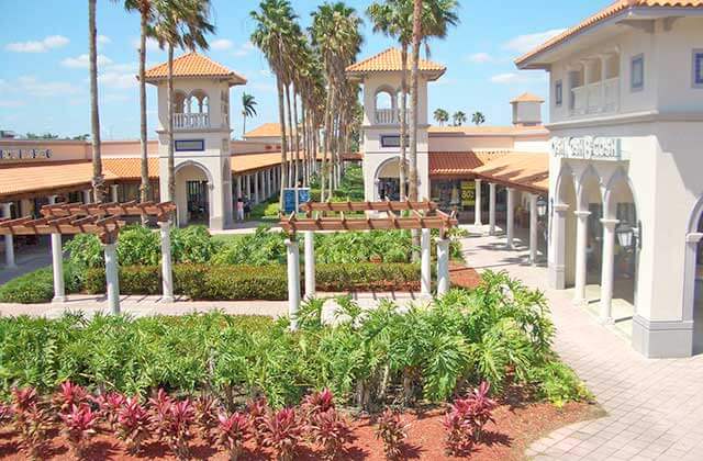 courtyard shops with landscaping and arbors with seating at florida keys outlet marketplace