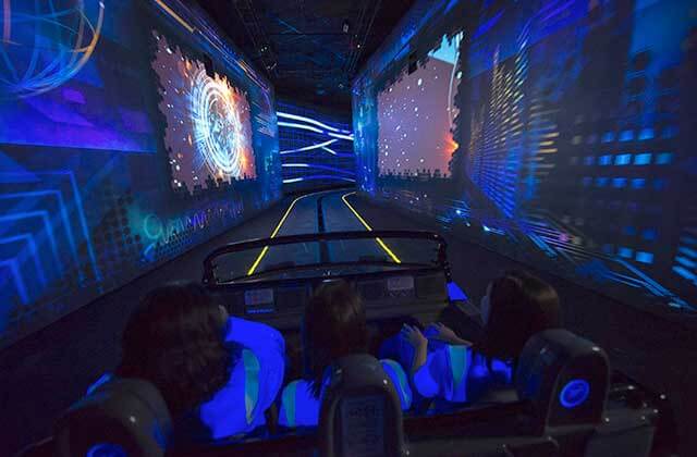 dark interior of a roller coaster ride with blacklight effects on test trac at disney epcot theme park orlando