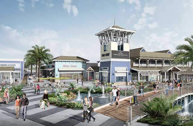 exterior of building with storefronts sidewalks trees and shoppers at tampa premium outlets florida