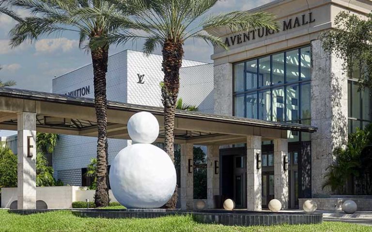 exterior front of mall with snowman sculpture and palm trees at aventura mall miami