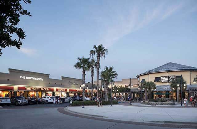 exterior shopping plaza with storefronts and parking at silver sands premium outlets miramar beach