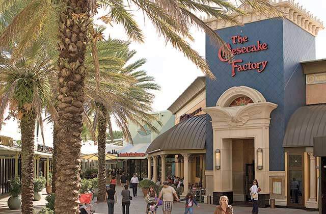 exterior stores with palm trees shoppers and cheesecake factory anchor at sawgrass mills mall sunrise florida