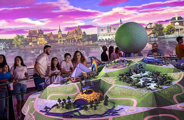 family of four viewing a large colorful model display park at disney epcot theme park orlando