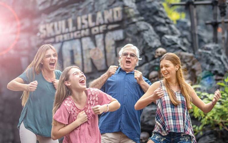 family of four pounding their chests at skull island at universal islands of adventure orlando