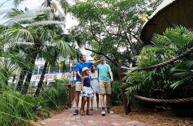family of four walking along path in a tropical area at jungle queen riverboats ft lauderdale