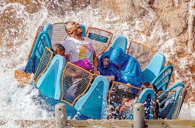 family on a raft ride getting soaked on infinity falls at seaworld theme park orlando