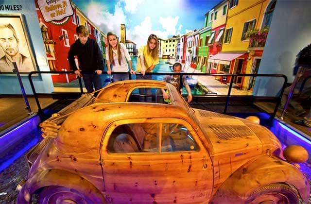 family with car made of wood at ripleys believe it or not panama city beach
