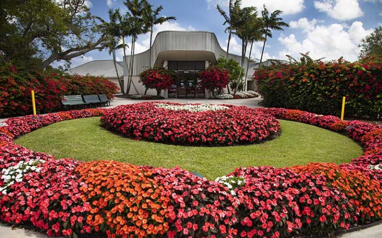front exterior entrance with red circular flower bed at butterfly world coconut creek