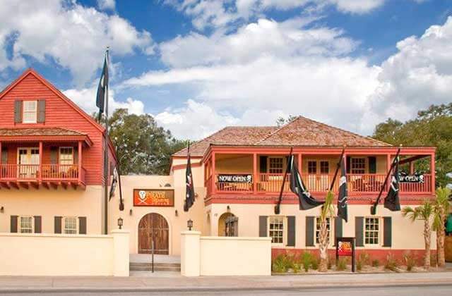 front exterior of building with pirate flags at st augustine pirate treasure museum florida