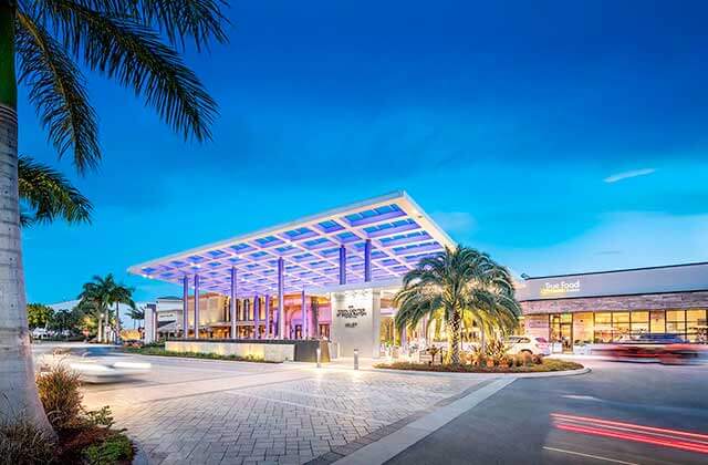 front exterior with lighting and palm trees at night at town center at boca raton florida