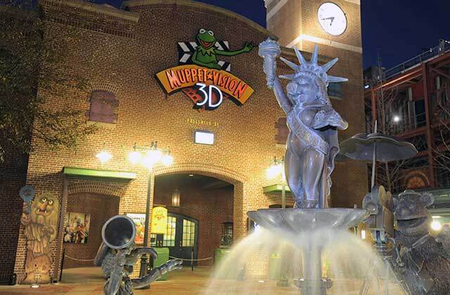 front exterior at night of muppets theater with miss piggy fountain at disneys hollywood studios theme park orlando