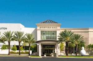 front exterior of shopping center with palm trees at aventura mall florida