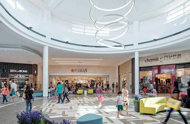 interior corridor of mall with chairs and shoppers at the florida mall orlando