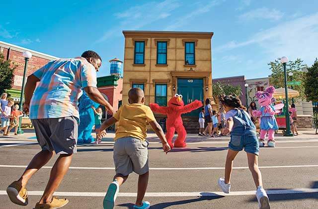 kids rush toward elmo character in a sesame street parade at seaworld theme park orlando