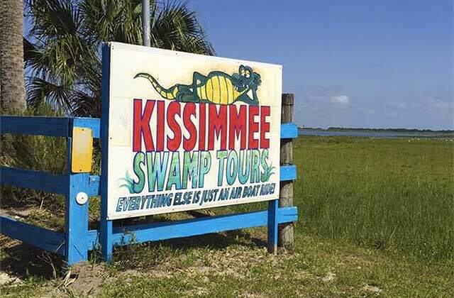 kissimmee swamp tours sign at the edge of marsh at kissimmee swamp tours