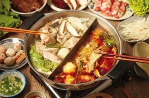 large two sided hot pot with different noodles and ingredients at volcano hot pot bbq kissimmee