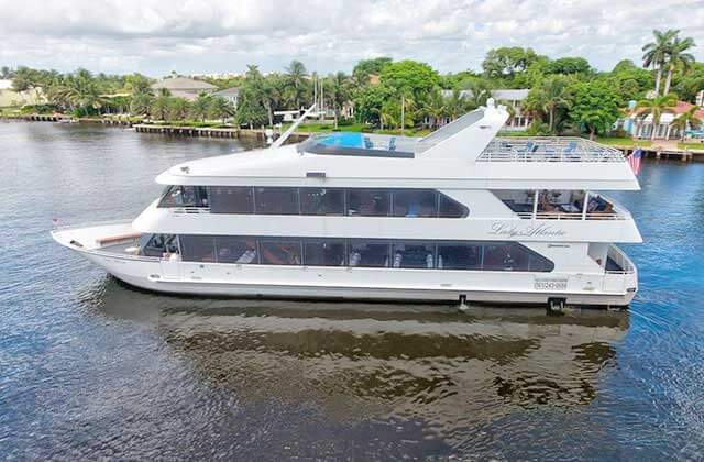 luxury yacht docked at inlet with homes at delray yacht cruises