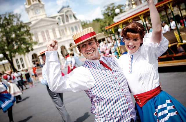 man and woman in period costume performing on main street area at disney magic kingdom theme park orlando