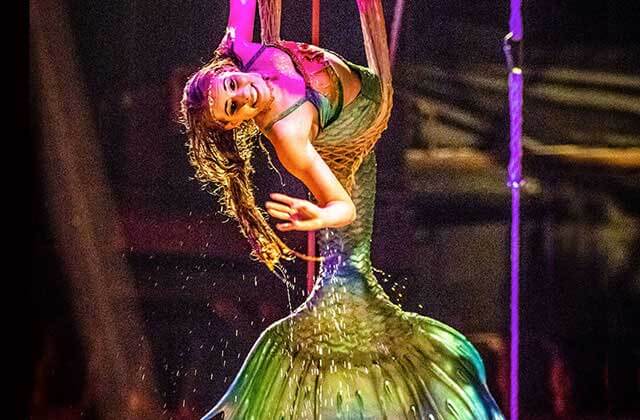 mermaid costumed performer swings above the ship deck at pirates dinner adventure orlando