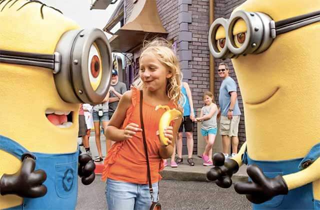 minions characters interacting with girl at universal studios florida theme park orlando