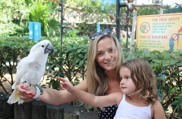mom with daughter holding cockatiel at miami seaquarium florida