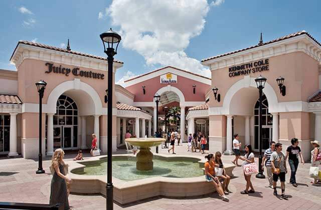 outdoor plaza with fountain and storefronts at orlando international premium outlets florida