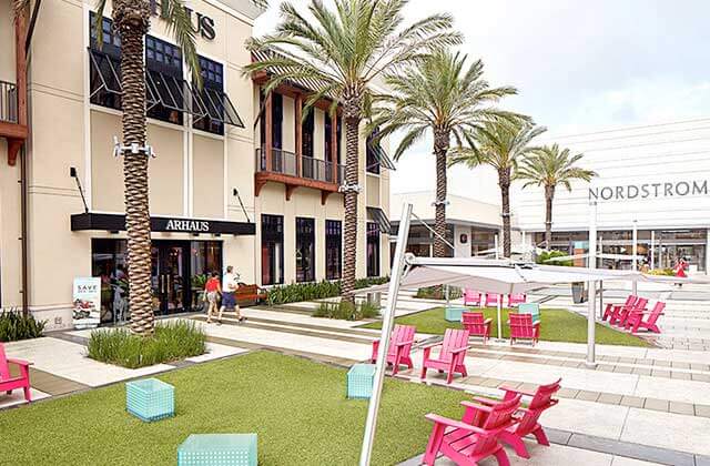 outside mall lawn seating area with nordstrom and arhaus storefronts at st johns town center jacksonville