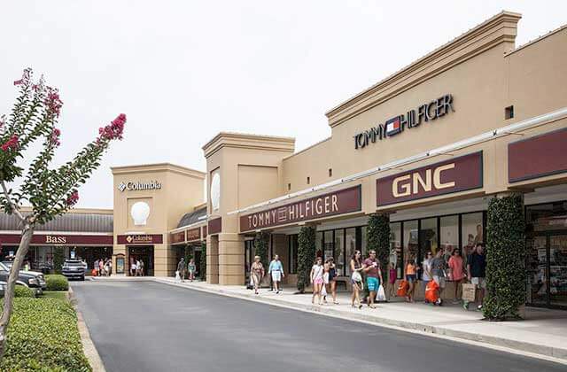 outside storefronts with designer brand names at silver sands premium outlets miramar beach