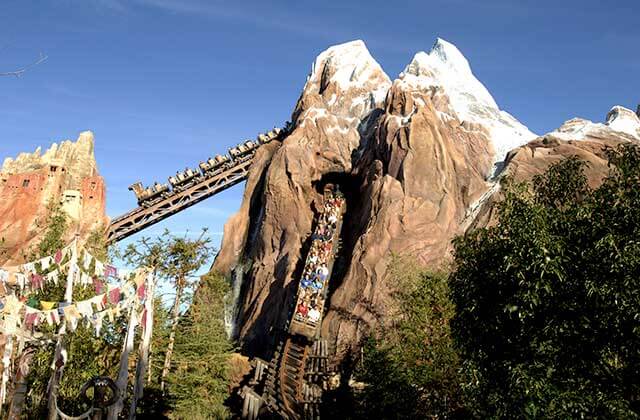 roller coaster ride with snow capped mountain on expedition everest at disneys animal kingdom theme park orlando