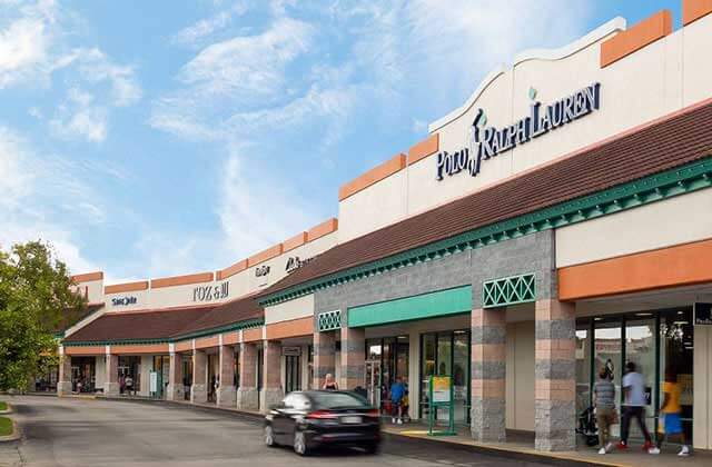 row of storefronts with polo ralph lauren sign at st augustine premium outlets florida