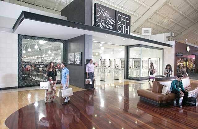 saks off 5th storefront with shoppers and corridor seating at sawgrass mills mall sunrise florida