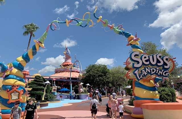 seuss landing entrance of themed area with families walking at universals islands of adventure theme park orlando