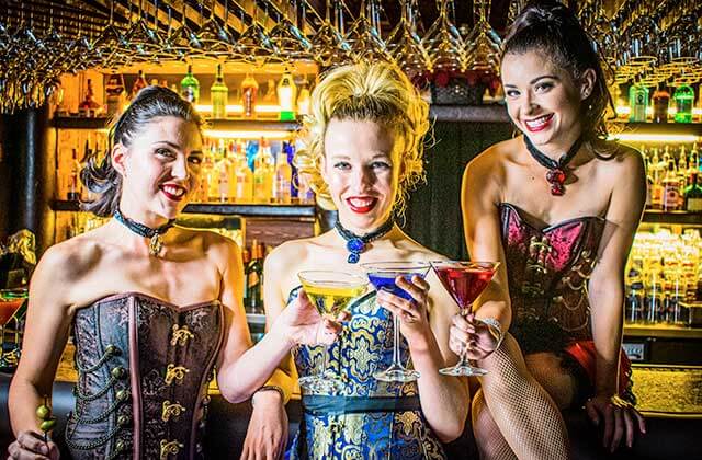 smiling showgirls at the bar with cocktails at teatro martini dinner comedy theatre orlando