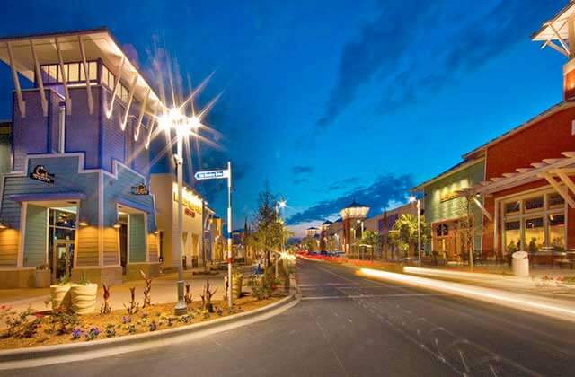 storefronts along the street with twilight sky at pier park panama city beach