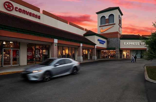 storefronts with converse and nike signs at twilight at st augustine premium outlets florida