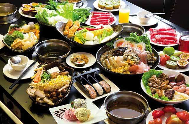 tabletop with large selection of hot pot ingredients at volcano hot pot bbq kissimmee