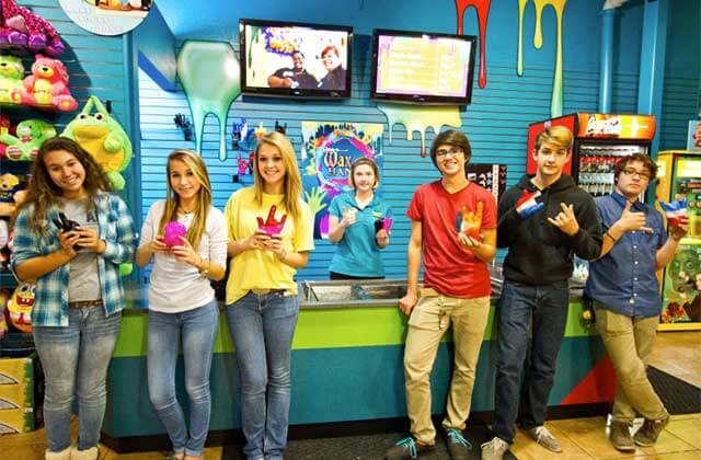 teens holding wax hand molds in the gift shop at ripleys believe it or not panama city beach
