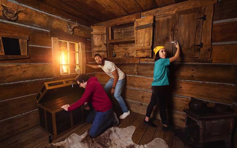 three young people search cabin at the escape room orlando