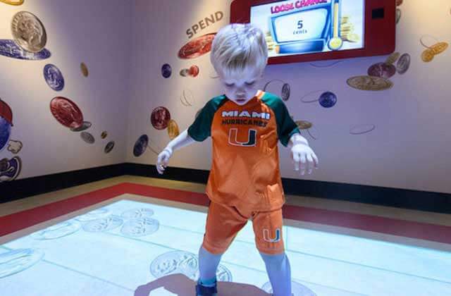 toddler boy steps along with light exhibit at miami childrens museum florida