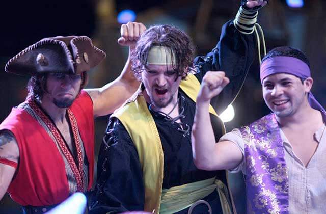 trio of costumed performer pirates cheer and sing at pirates dinner adventure orlando