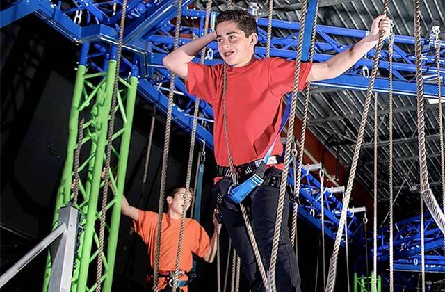 two boys navigating a ropes course at off the wall gamezone coconut creek florida