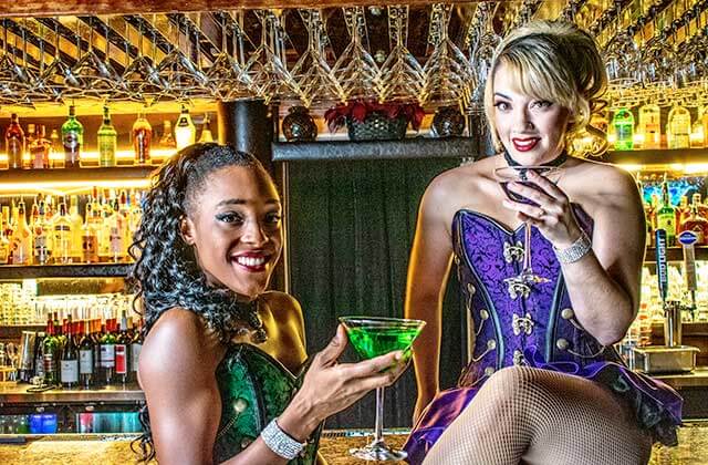 two showgirls at the bar holding cocktails at teatro martini dinner comedy theatre orlando