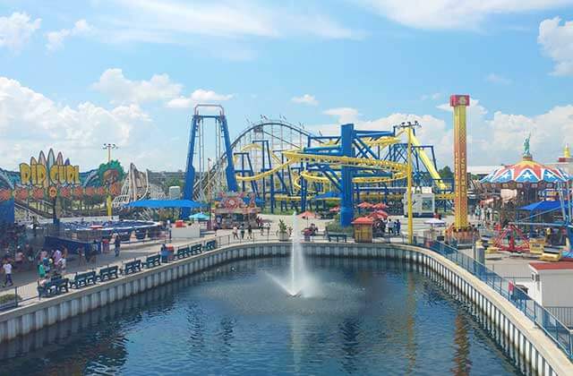 view across the water of multiple fair rides at fun spot america orlando