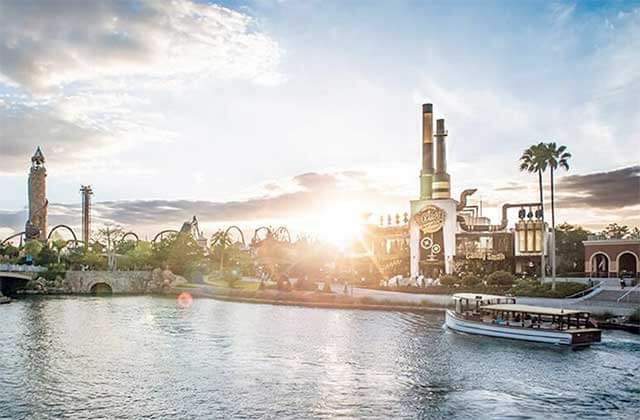 view over water of universal theme parks with sunrise skyline at universal citywalk orlando