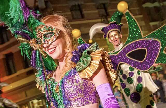 woman and man dressed in mardi gras costume for parade at universal studios florida theme park orlando