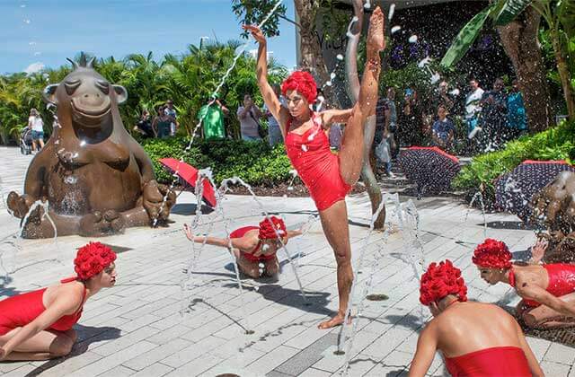 women in swimsuits performing at the splashpad at aventura mall florida